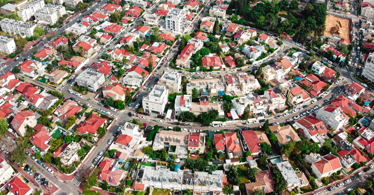 Colorful aerial view of a residential area in Holon, Israel showcasing rooftops and urban planning.